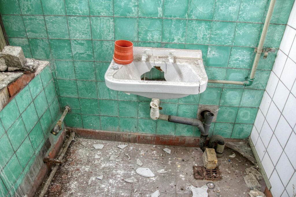 Demolished Lavatory with Rusty Pipes